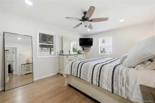 a bedroom with a large bed and flat tv