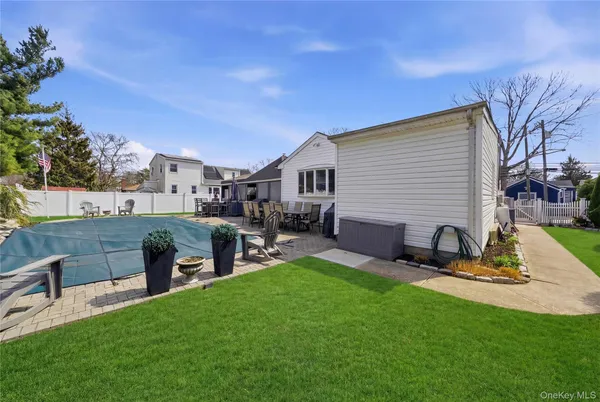 a front view of a house with a garden and trees