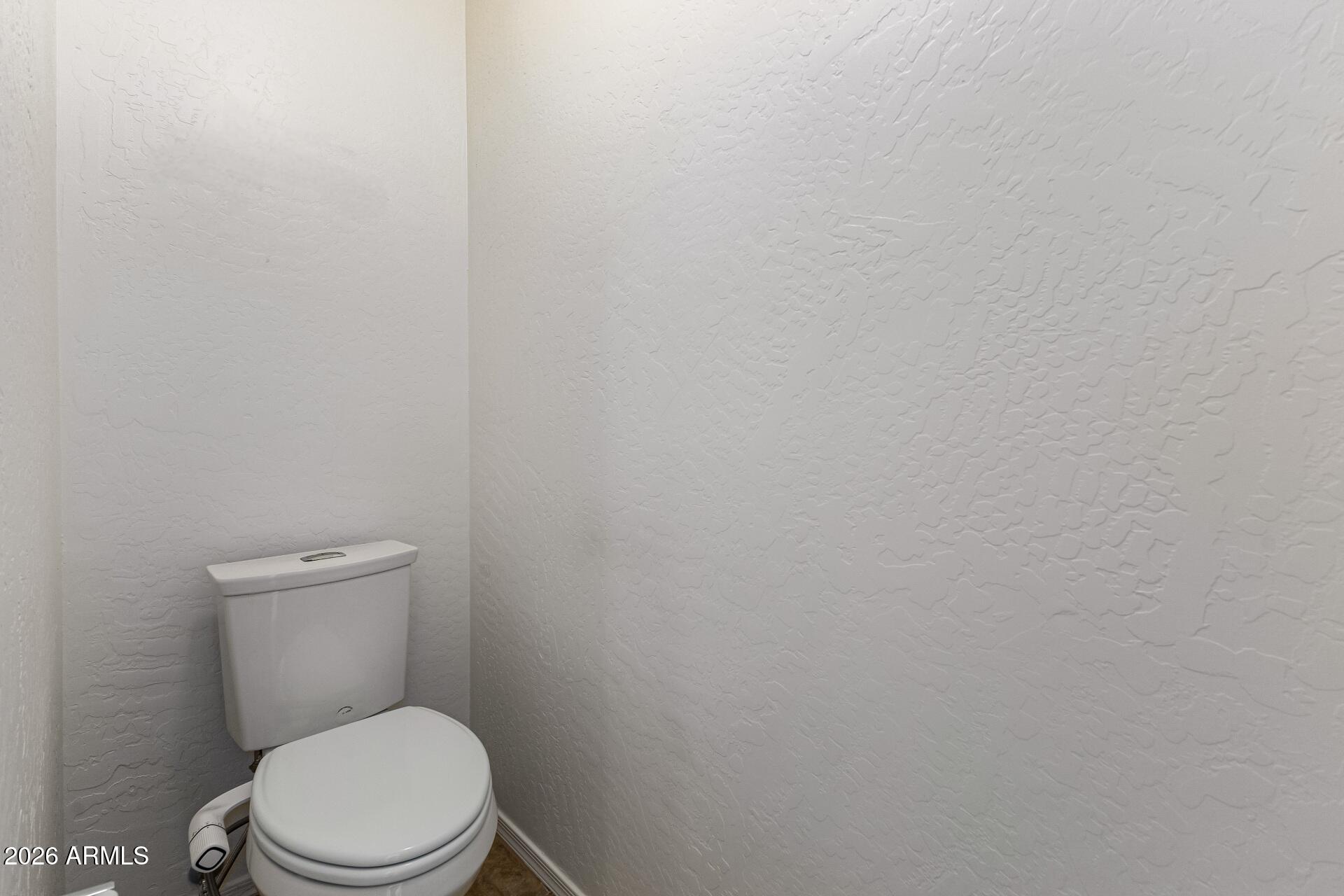 4208 South Sawmill Road Gilbert, AZ 85297 - Photo 23 of 46 a white toilet sitting next to a white wall