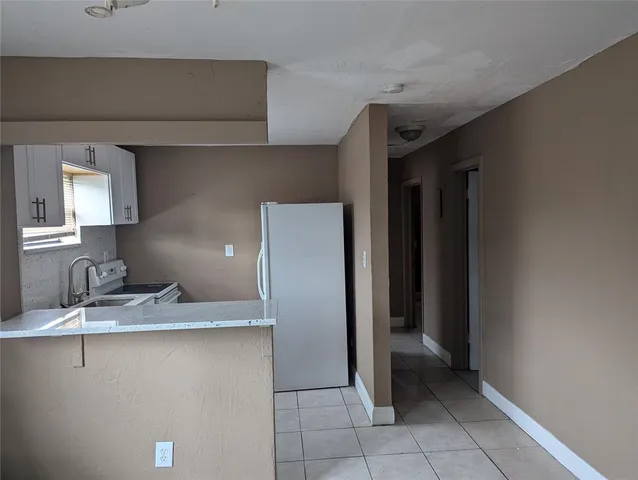 a kitchen with a sink and a refrigerator