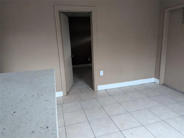 a view of storage and utility room with refrigerator