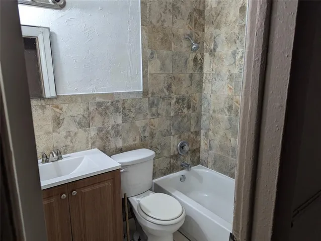 a bathroom with a toilet a sink and a bathtub