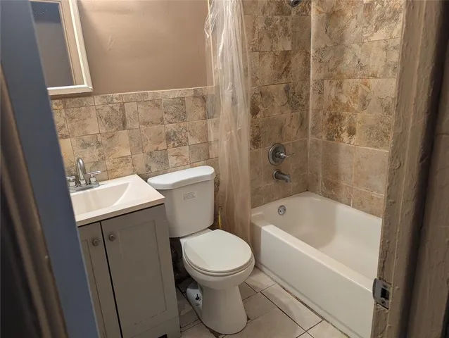 a bathroom with a toilet a sink and bathtub