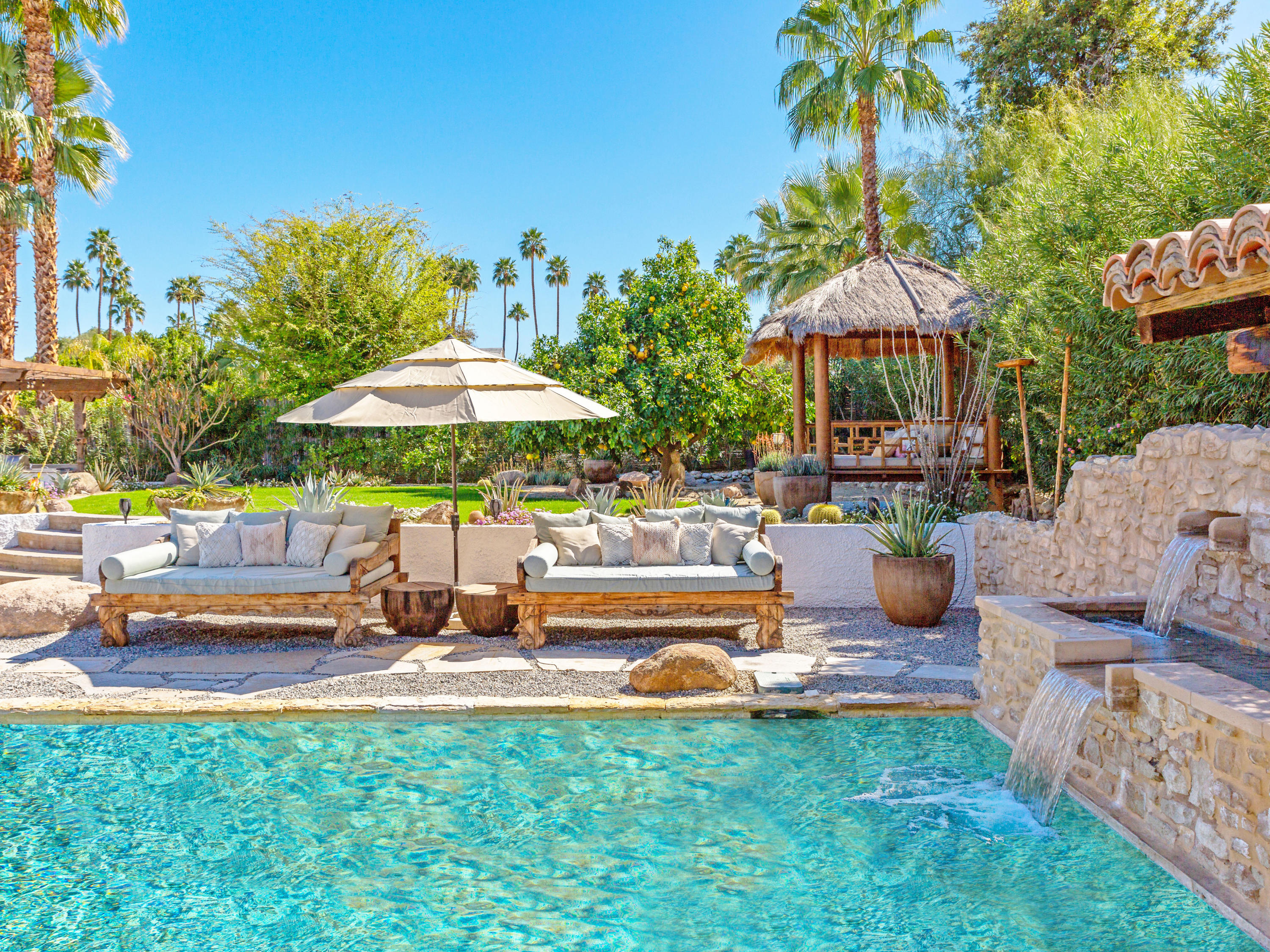 71607 Sahara Road Rancho Mirage, CA 92270 - Photo 2 of 40 a view of a patio with a table and chairs under an umbrella