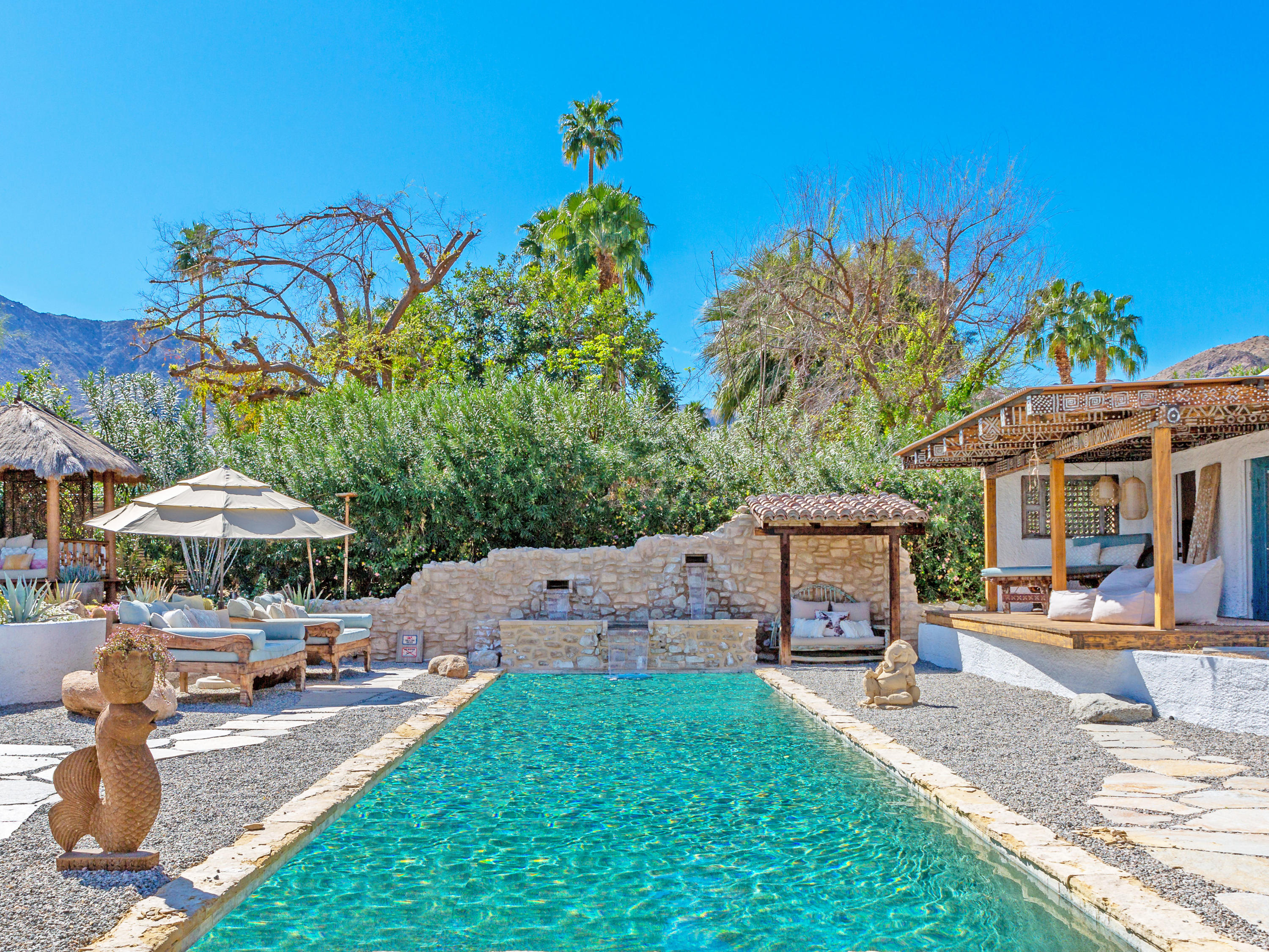 71607 Sahara Road Rancho Mirage, CA 92270 - Photo 34 of 40 a patio area with table and chairs under an umbrella