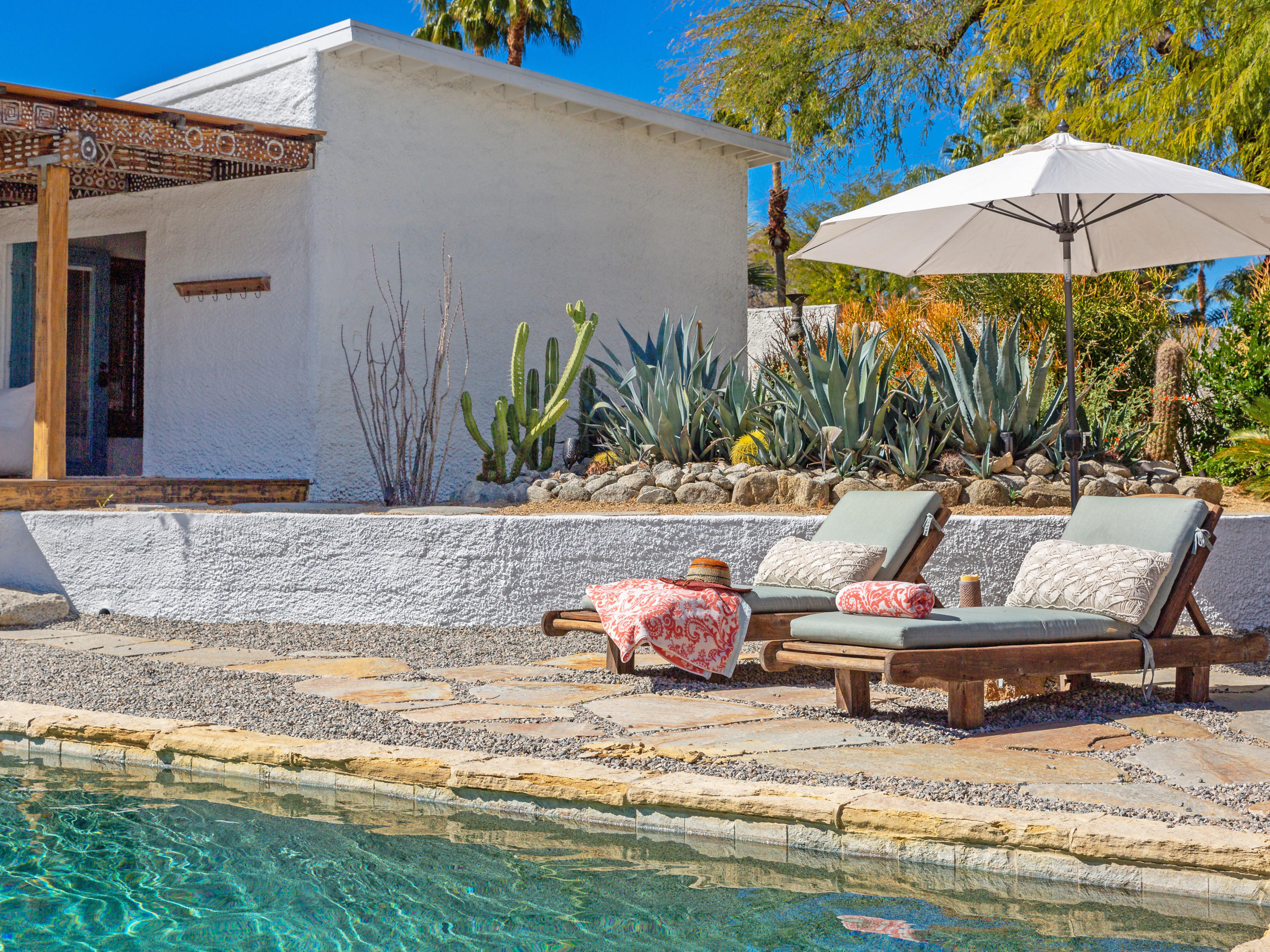 71607 Sahara Road Rancho Mirage, CA 92270 - Photo 35 of 40 a view of swimming pool with lawn chairs under an umbrella