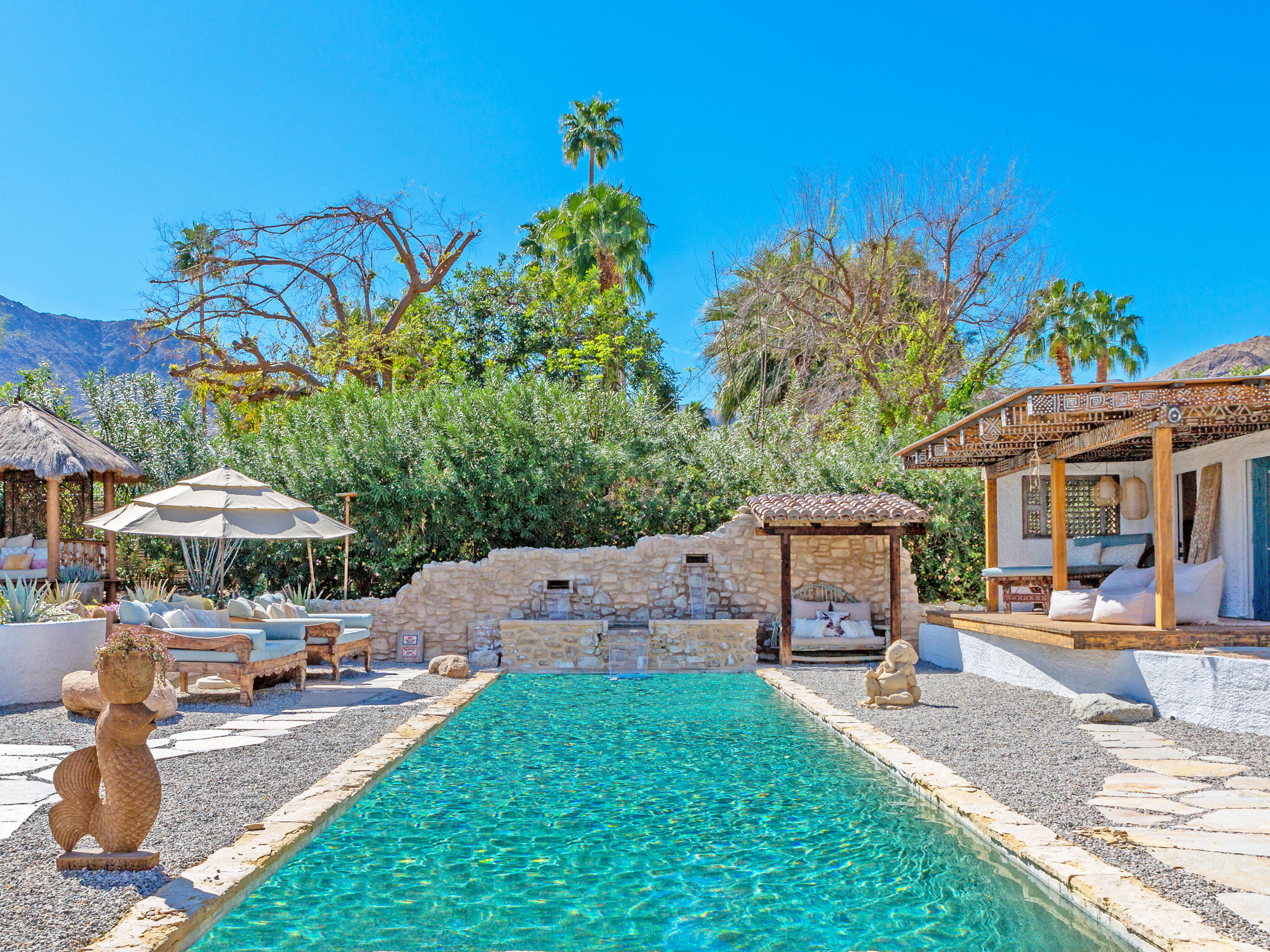 71607 Sahara Road Rancho Mirage, CA 92270 - Photo 8 of 40 a patio area with table and chairs under an umbrella