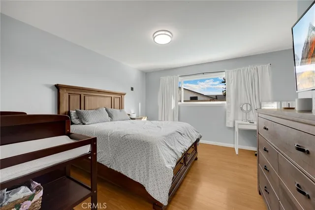 a bedroom with a bed and cabinet