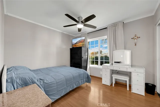 a bedroom with a bed and a large window