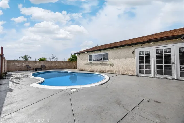a view of a swimming pool with an outdoor seating area