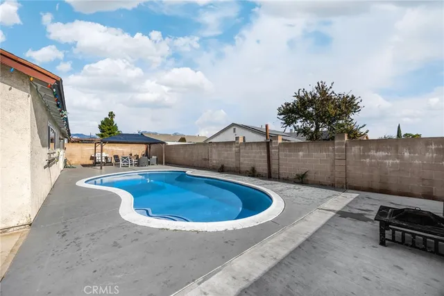 a swimming pool with view of lake in the background