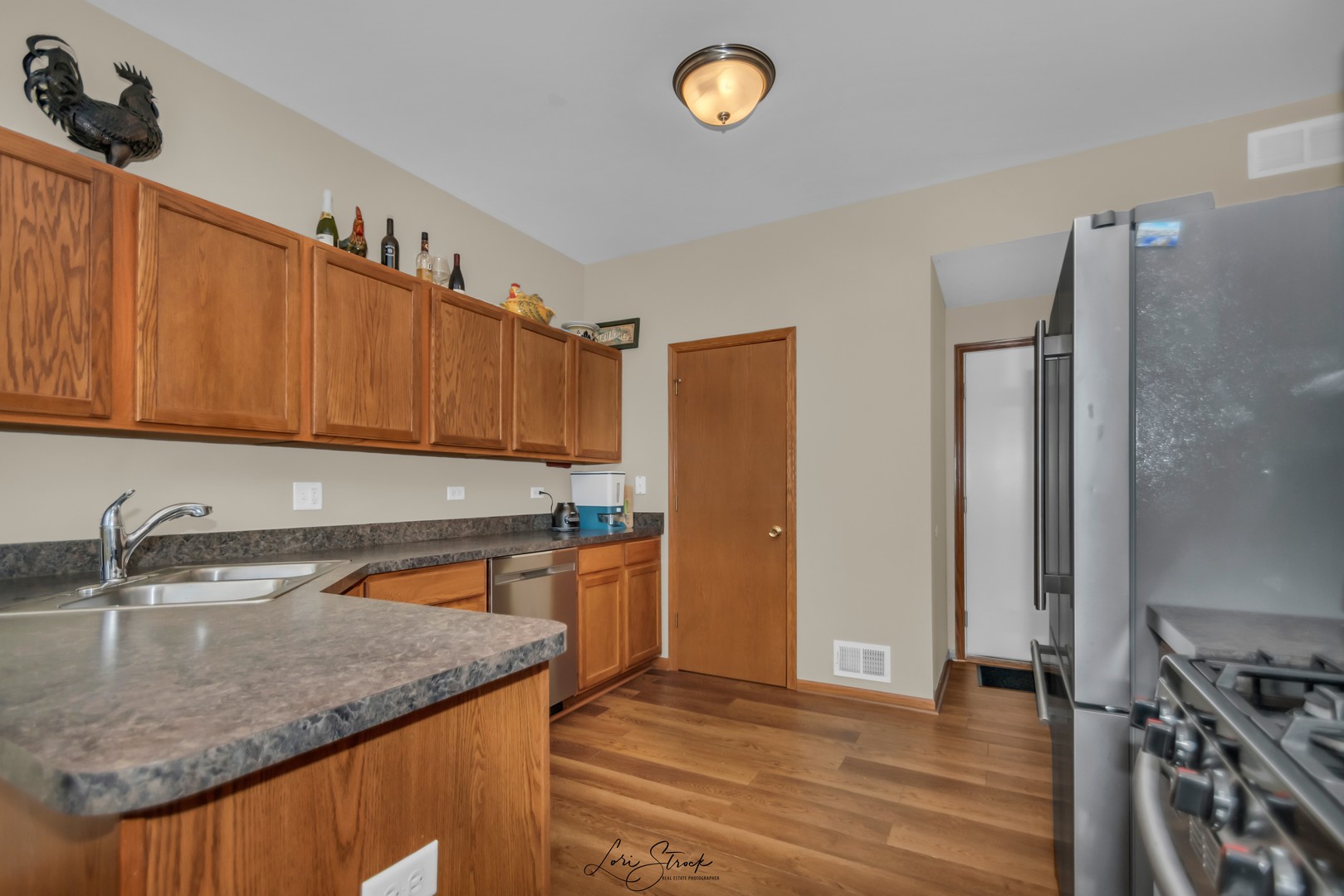 25009 Clare Circle Manhattan, IL 60442 - Photo 11 of 20 a kitchen with stainless steel appliances granite countertop a sink refrigerator and cabinets