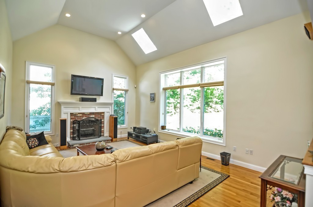 316 Hartman Road Newton, MA 02459 - Photo 12 of 30 a living room with fireplace furniture and a flat screen tv