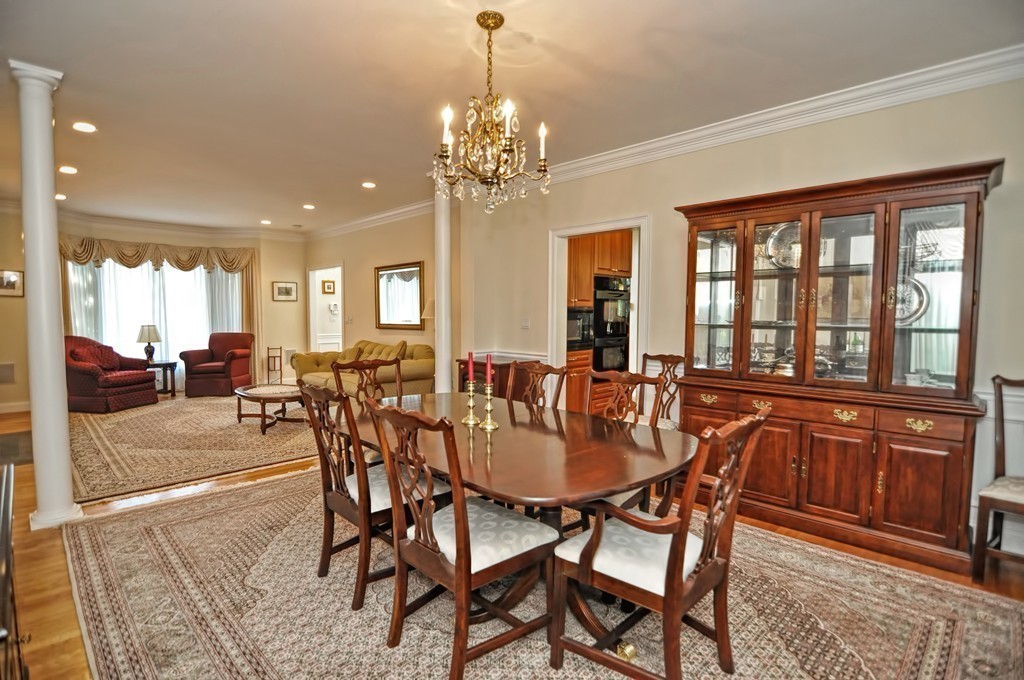 316 Hartman Road Newton, MA 02459 - Photo 15 of 30 a dining room with furniture a chandelier and wooden floor