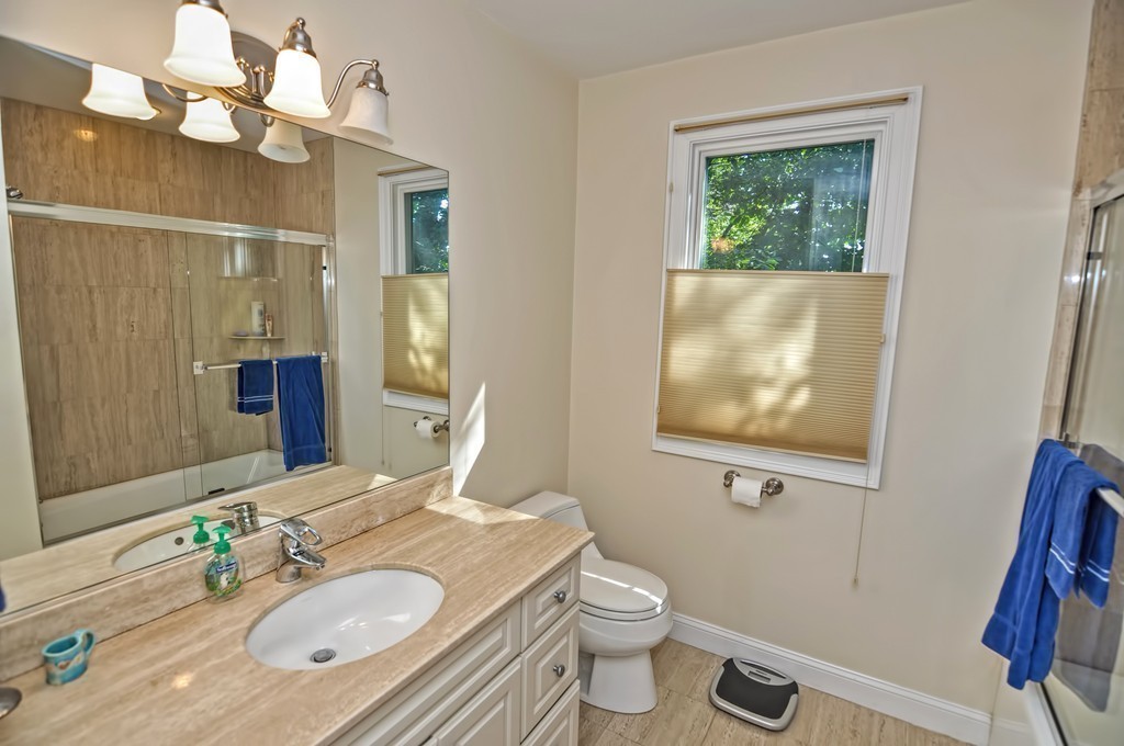 316 Hartman Road Newton, MA 02459 - Photo 19 of 30 a bathroom with a granite countertop sink mirror vanity and toilet