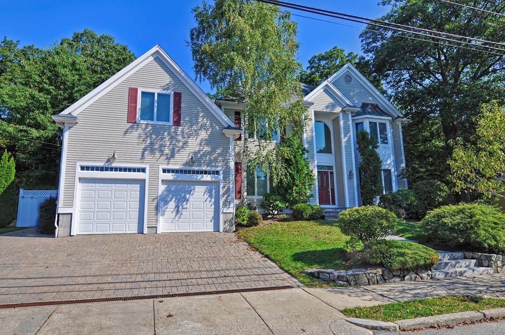 316 Hartman Road Newton, MA 02459 - Photo 2 of 30 a front view of a house with a yard and garage