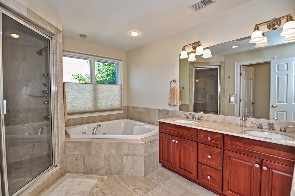 316 Hartman Road Newton, MA 02459 - Photo 27 of 30 a spacious bathroom with a tub sink shower and mirror