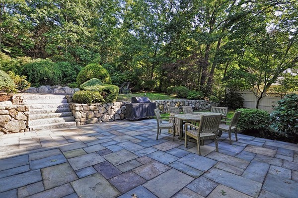 316 Hartman Road Newton, MA 02459 - Photo 4 of 30 a view of a patio with table and chairs and potted plants