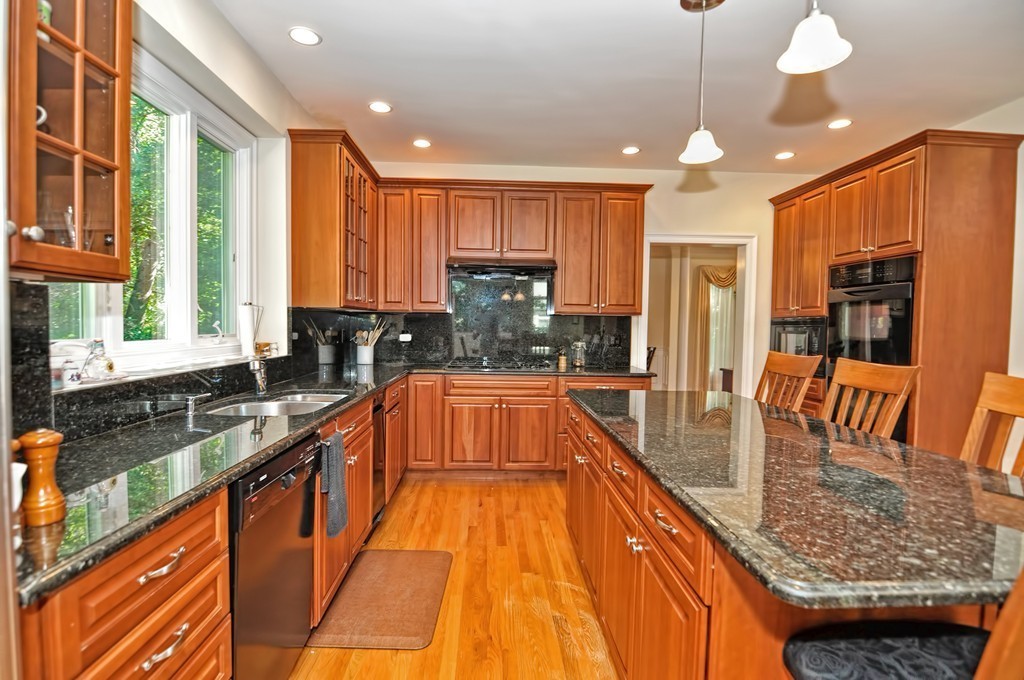 316 Hartman Road Newton, MA 02459 - Photo 9 of 30 a large kitchen with stainless steel appliances granite countertop a stove a sink and a microwave
