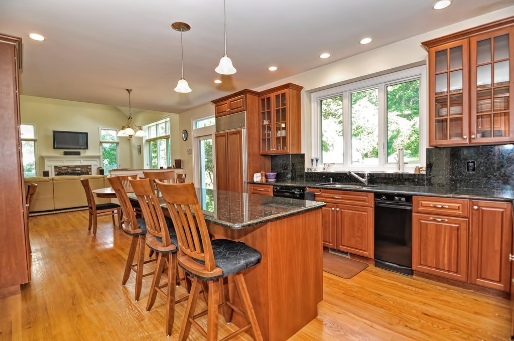 316 Hartman Road Newton, MA 02459 - Photo 10 of 30 a kitchen with stainless steel appliances granite countertop a stove top oven a sink dishwasher a dining table and chairs with wooden floor