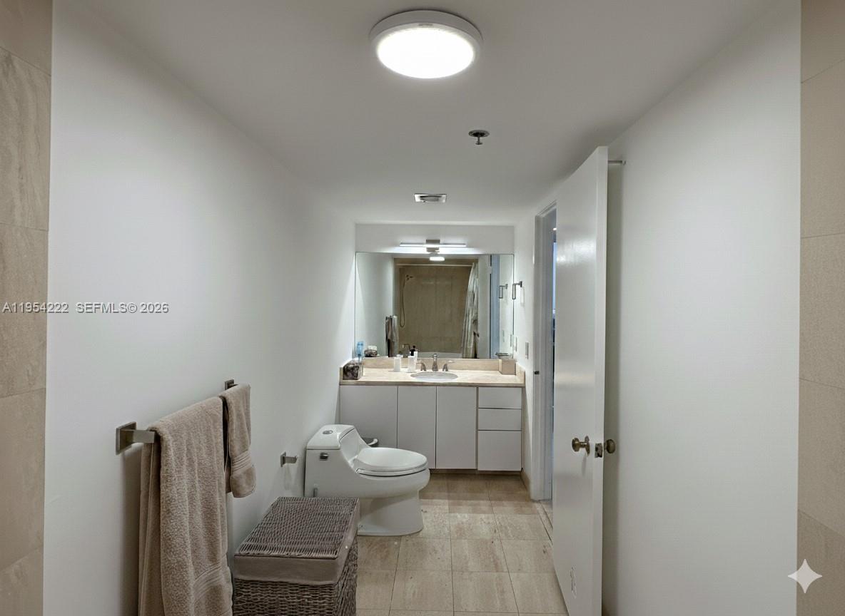 201 Crandon Boulevard, Unit 928 Key Biscayne, FL 33149 - Photo 14 of 38 a bathroom with a sink mirror and toilet