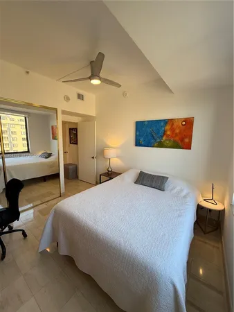 a bedroom with a bed and ceiling fan