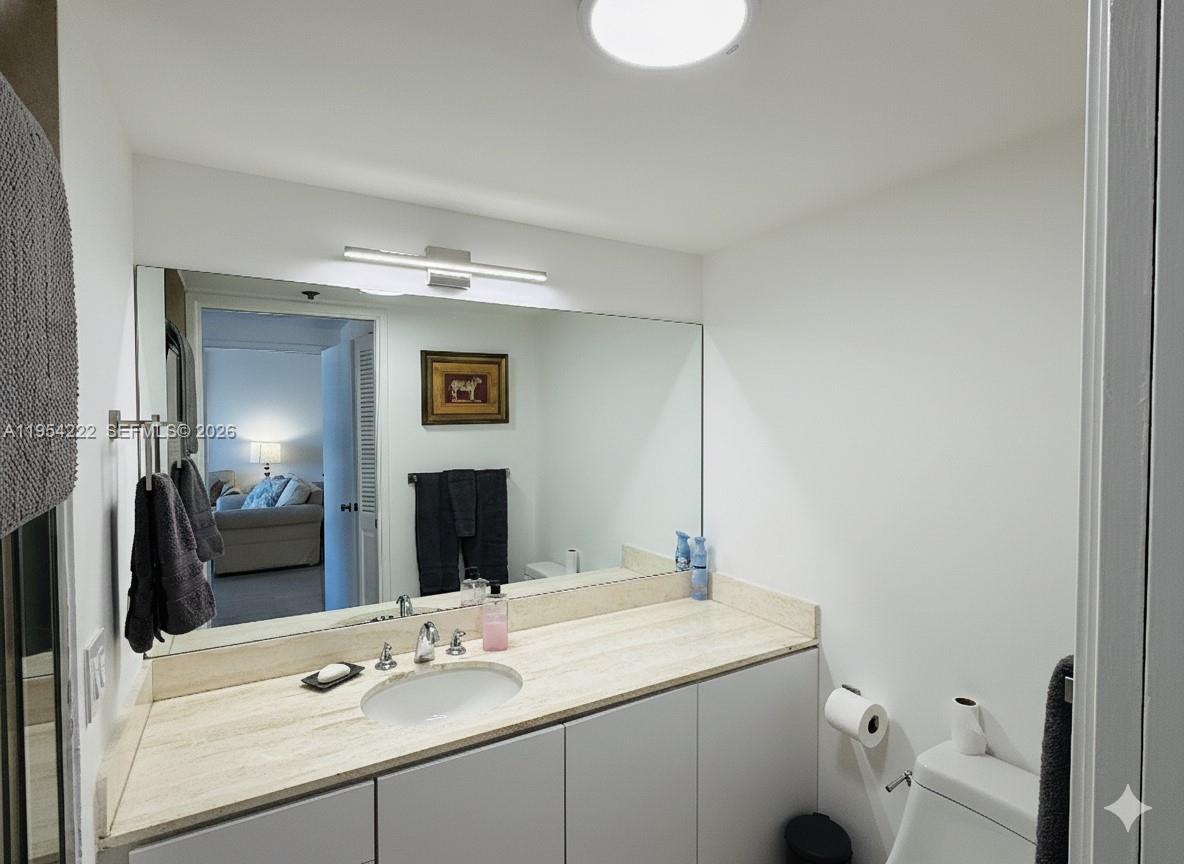 201 Crandon Boulevard, Unit 928 Key Biscayne, FL 33149 - Photo 19 of 38 a bathroom with a sink and a mirror