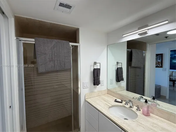 a bathroom with a sink and a mirror