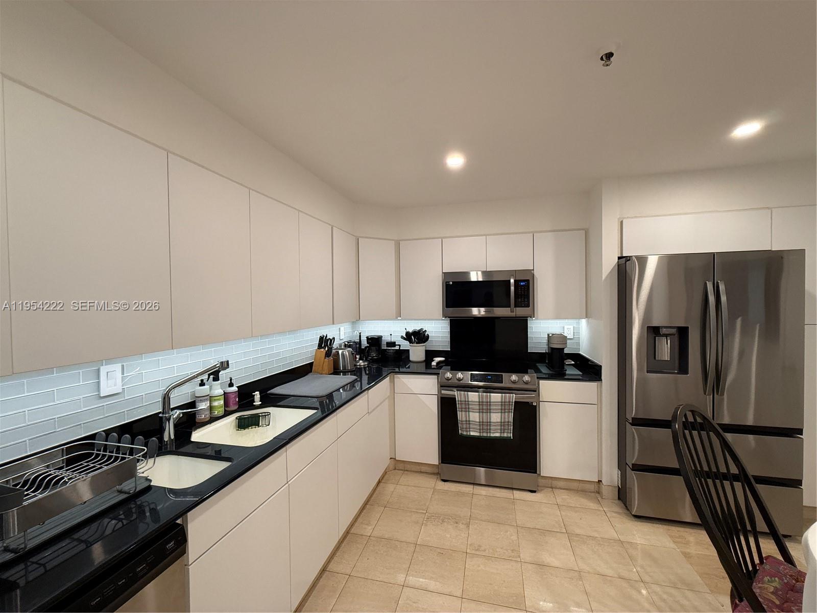 201 Crandon Boulevard, Unit 928 Key Biscayne, FL 33149 - Photo 21 of 38 a kitchen with a sink a stove and refrigerator