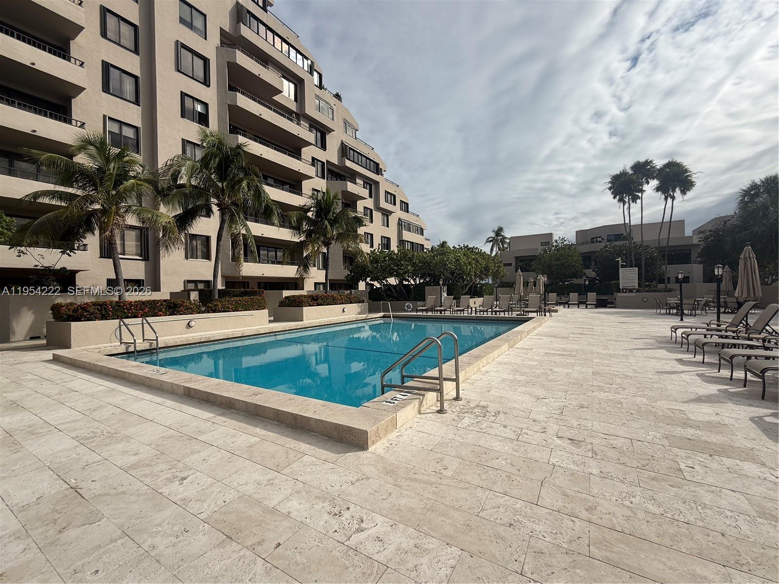 201 Crandon Boulevard, Unit 928 Key Biscayne, FL 33149 - Photo 27 of 38 an outdoor space with swimming pool and furniture