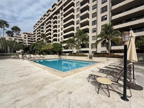 a swimming pool with outdoor seating and yard