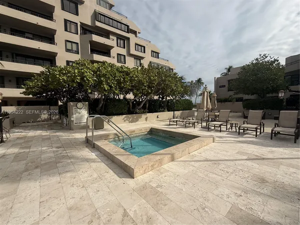 a swimming pool with outdoor seating and yard