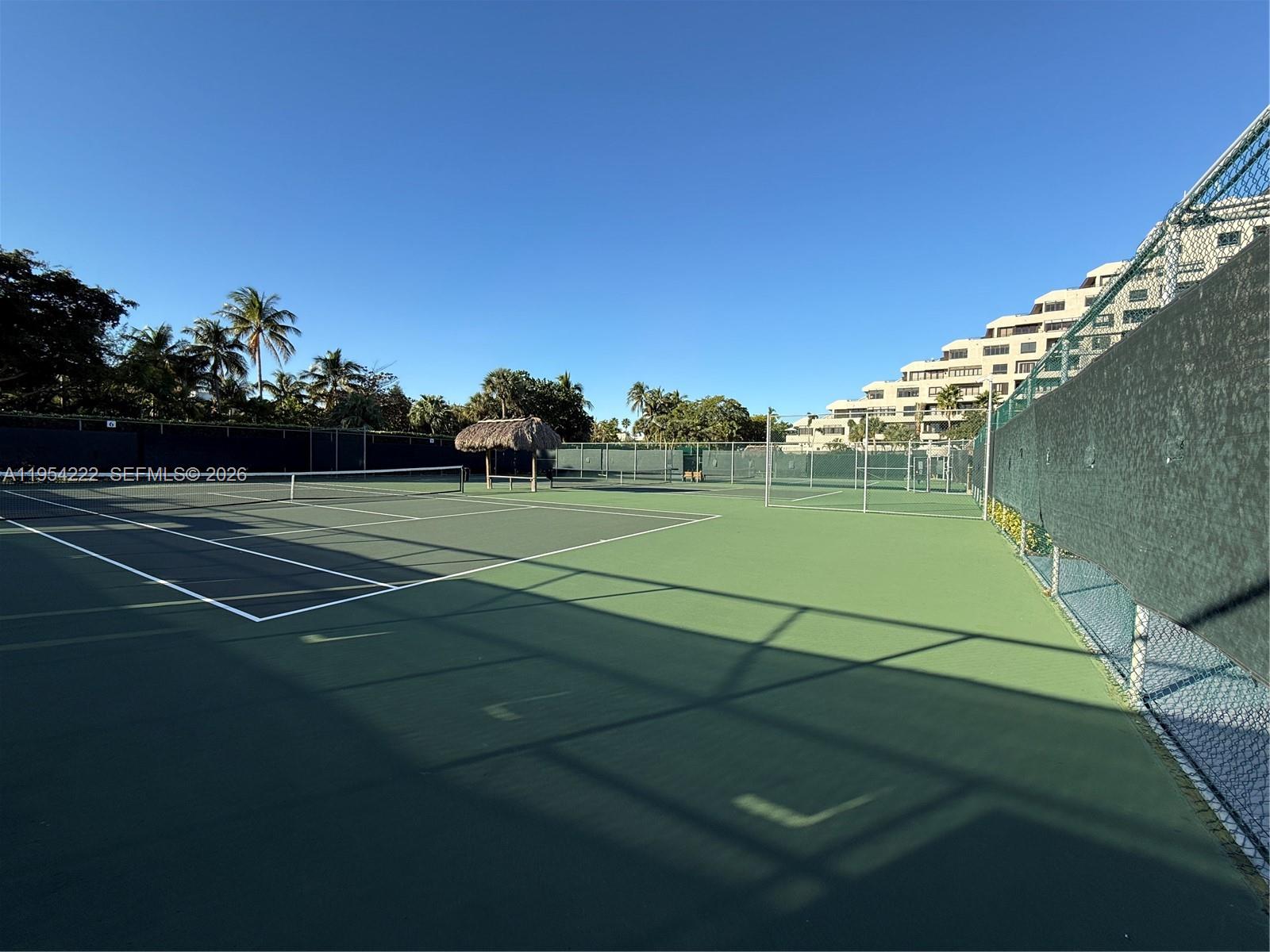 201 Crandon Boulevard, Unit 928 Key Biscayne, FL 33149 - Photo 32 of 38 a view of a tennis ground with large trees
