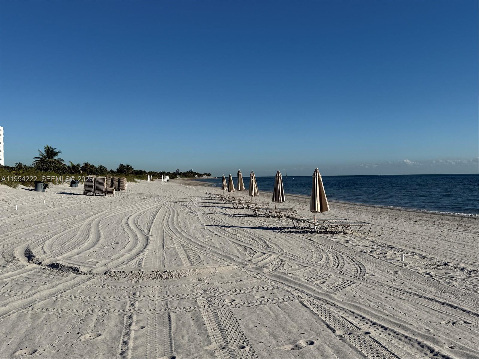 201 Crandon Boulevard, Unit 928 Key Biscayne, FL 33149 - Photo 37 of 38 a view of a bedroom with a bed and a chandelier