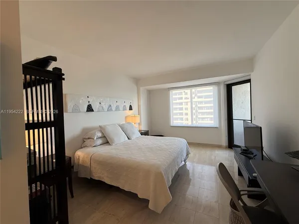 a bedroom with a bed and a desk