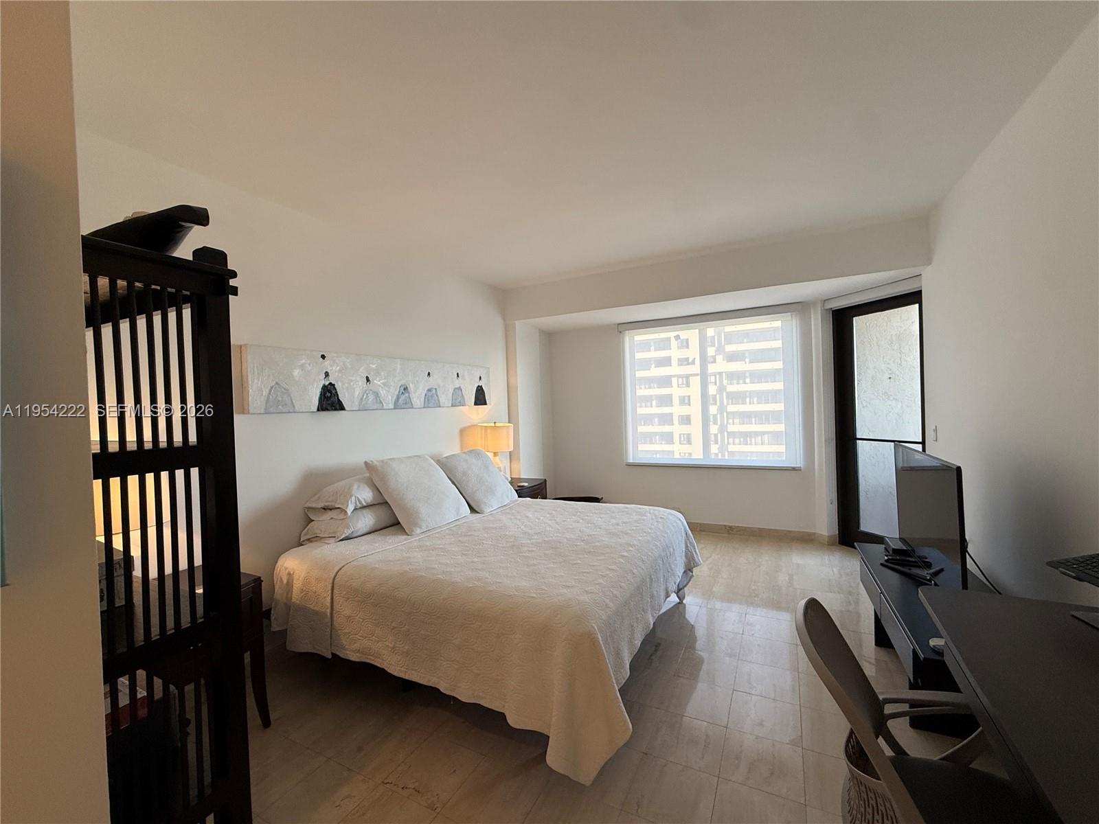 201 Crandon Boulevard, Unit 928 Key Biscayne, FL 33149 - Photo 8 of 38 a bedroom with a bed and a desk