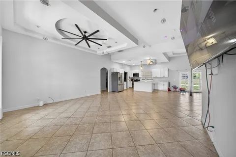 a view of a livingroom with furniture and chandelier fan