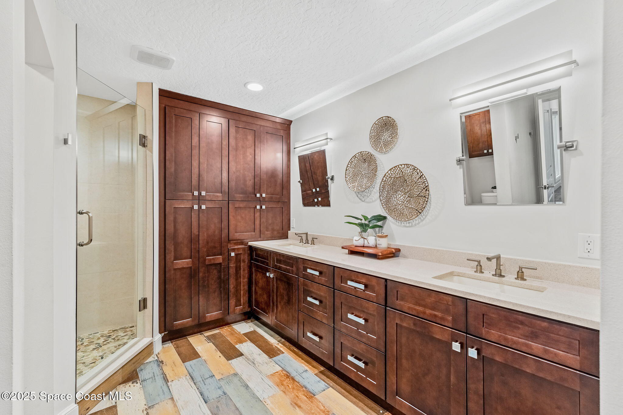 8535 South Tropical Trail Merritt Island, FL 32952 - Photo 15 of 44 a spacious bathroom with a double vanity sink mirror and shower