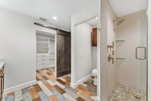 a bathroom with a shower and a sink