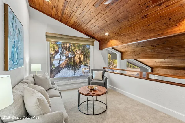 a living room with furniture a rug and a large window