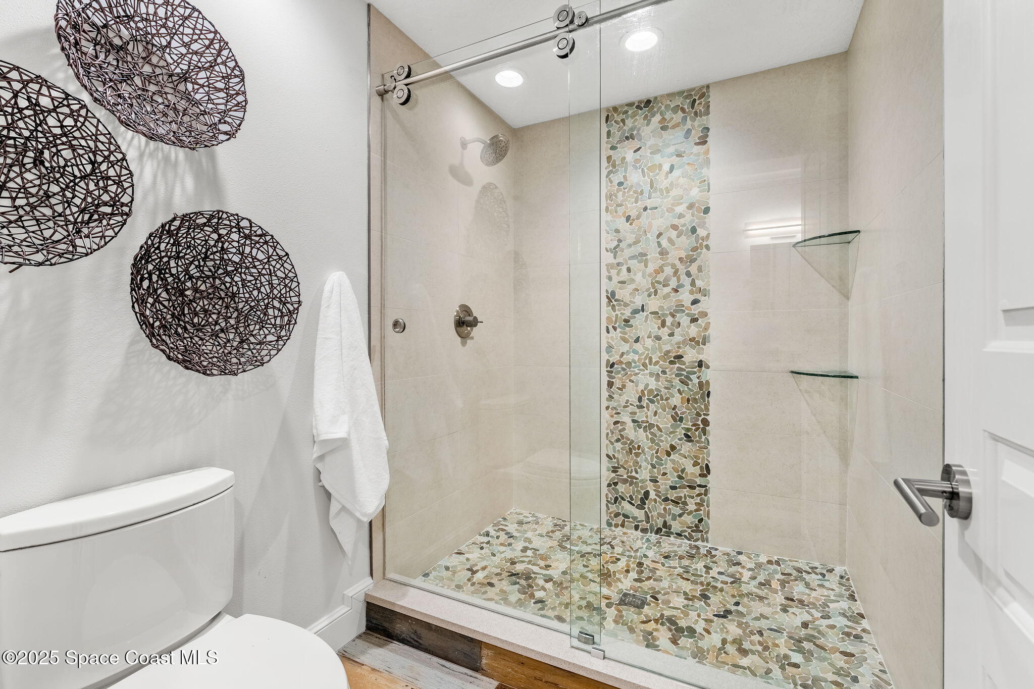 8535 South Tropical Trail Merritt Island, FL 32952 - Photo 24 of 44 a bathroom with a toilet and a shower