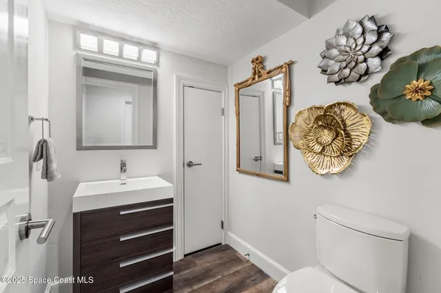 a bathroom with a sink a mirror and a toilet