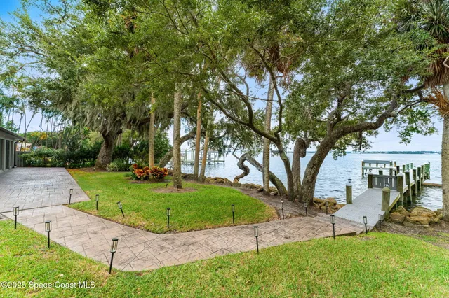 a view of a park with bench and trees