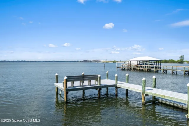 a view of house with outdoor seating yard and lake view