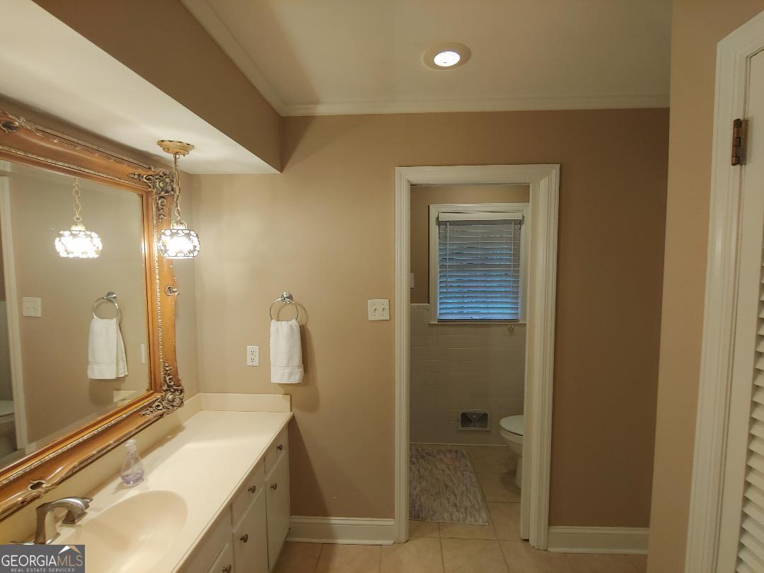 428 Wesleyan Drive Macon, GA 31210 - Photo 11 of 26 a bathroom with a granite countertop sink and a mirror