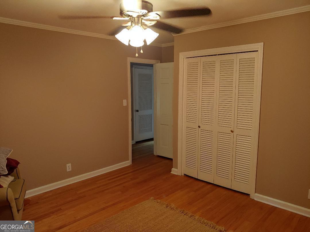 428 Wesleyan Drive Macon, GA 31210 - Photo 13 of 26 an empty room with wooden floor closet and windows