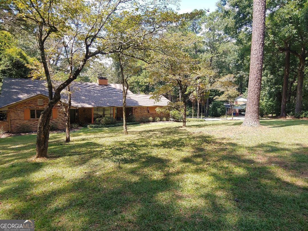 428 Wesleyan Drive Macon, GA 31210 - Photo 25 of 26 a backyard of a house with swimming pool and trees