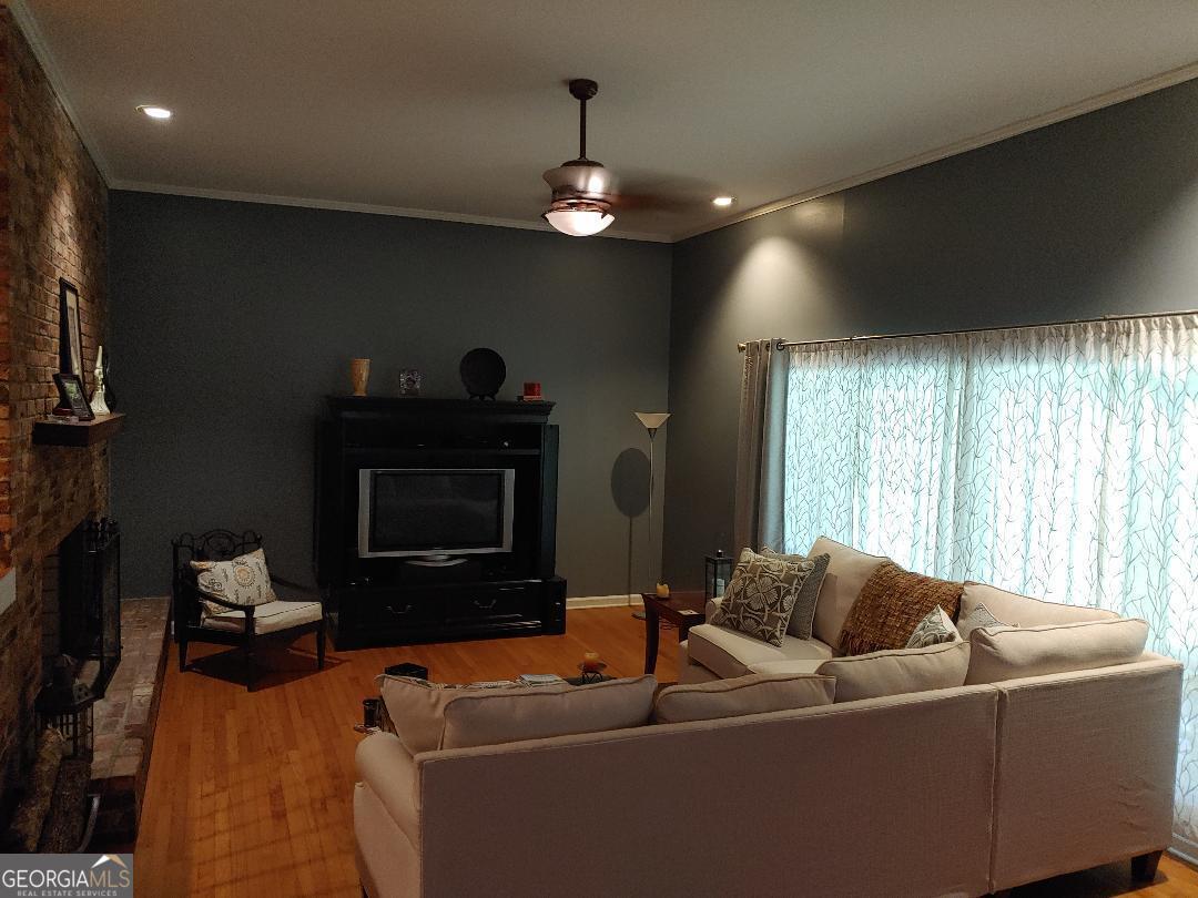 428 Wesleyan Drive Macon, GA 31210 - Photo 5 of 26 a living room with furniture a fireplace and a flat screen tv