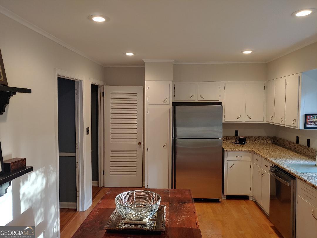 428 Wesleyan Drive Macon, GA 31210 - Photo 7 of 26 a kitchen with stainless steel appliances granite countertop a refrigerator and a sink