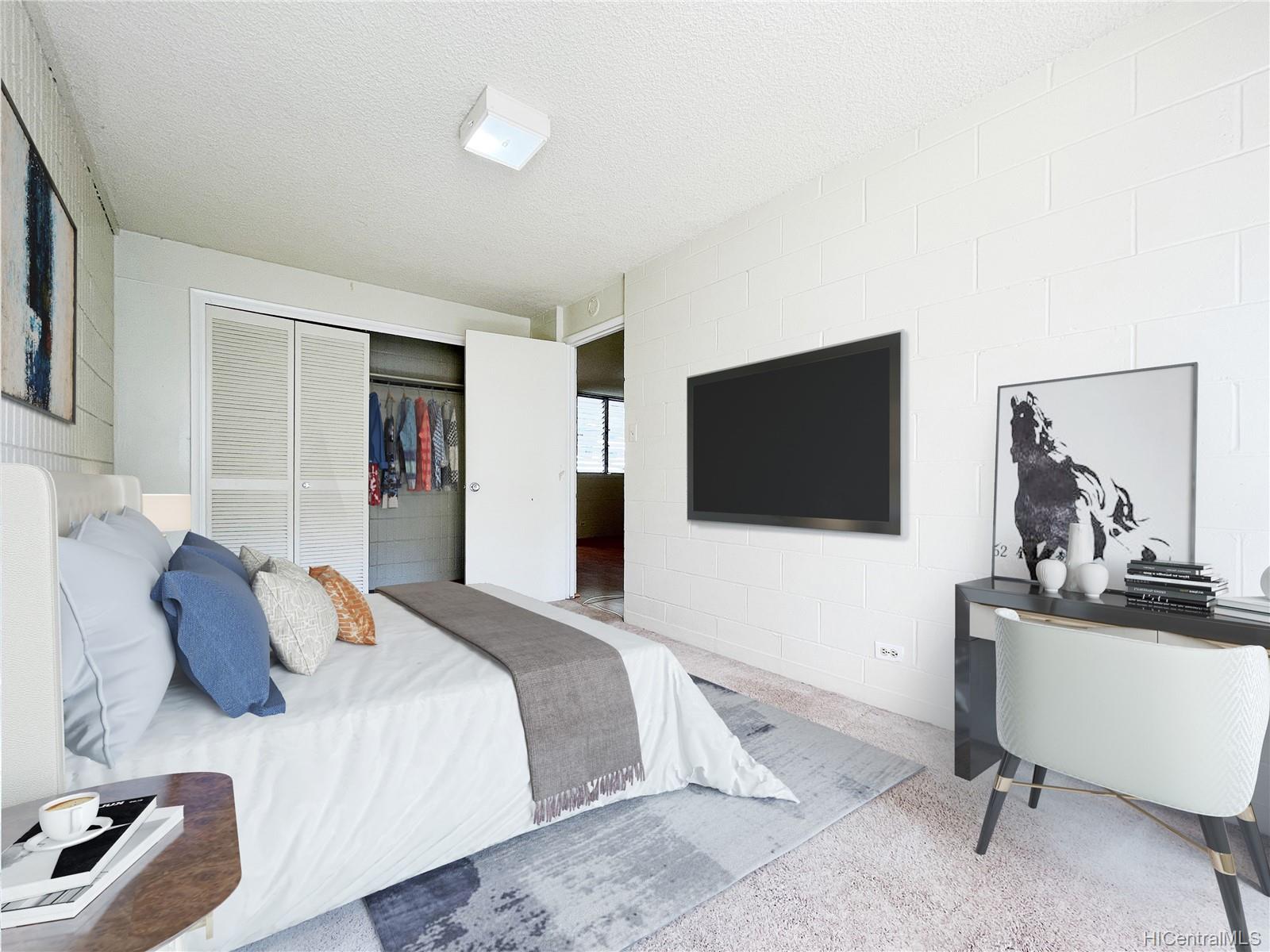 a bedroom with a bed and a flat screen tv